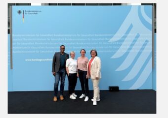 Group picture of telemedicine team in front of the German Minsitry of Health banner