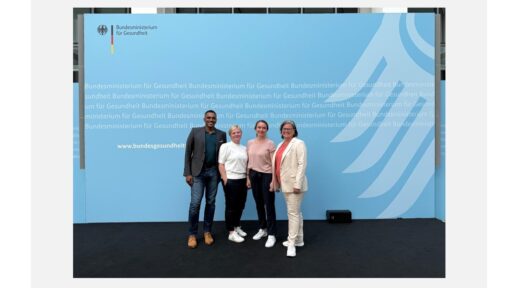 Group picture of telemedicine team in front of the German Minsitry of Health banner