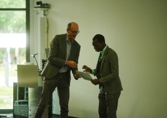 Two men handing over to each other a document