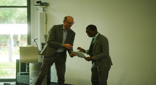 Two men handing over to each other a document